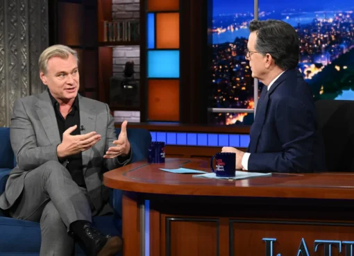 Christopher Nolan smiling during an interview.