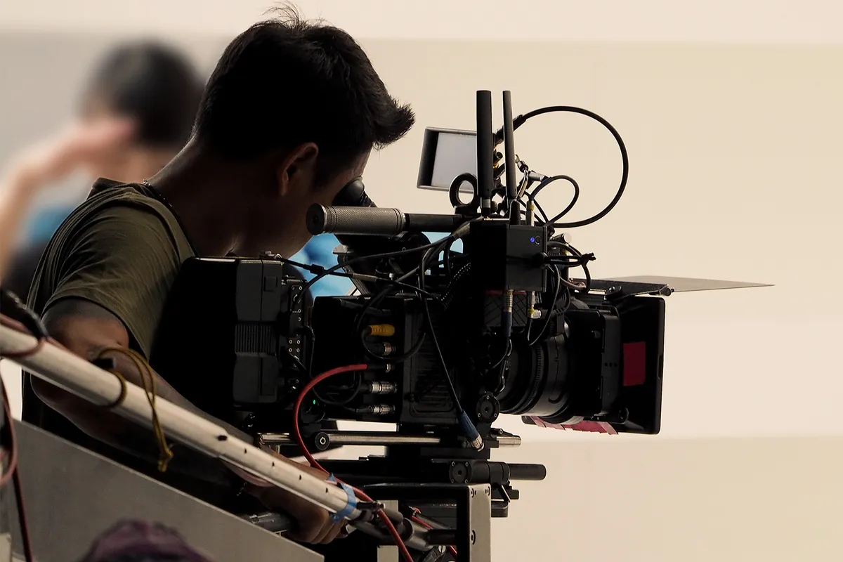 Film crew with cameras on a vibrant Culver City street.