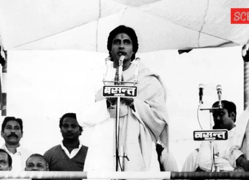 Amitabh Bachchan in a formal suit, looking thoughtful.