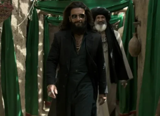 Ranveer Singh and Sara Arjun looking thoughtful in a scene from 'Dhurandhar 2' against a muted backdrop.
