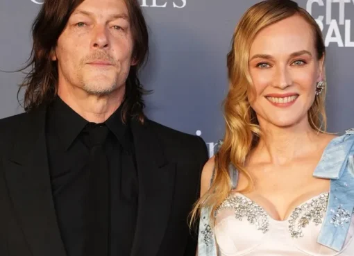 Diane Kruger and Norman Reedus smiling on the red carpet.