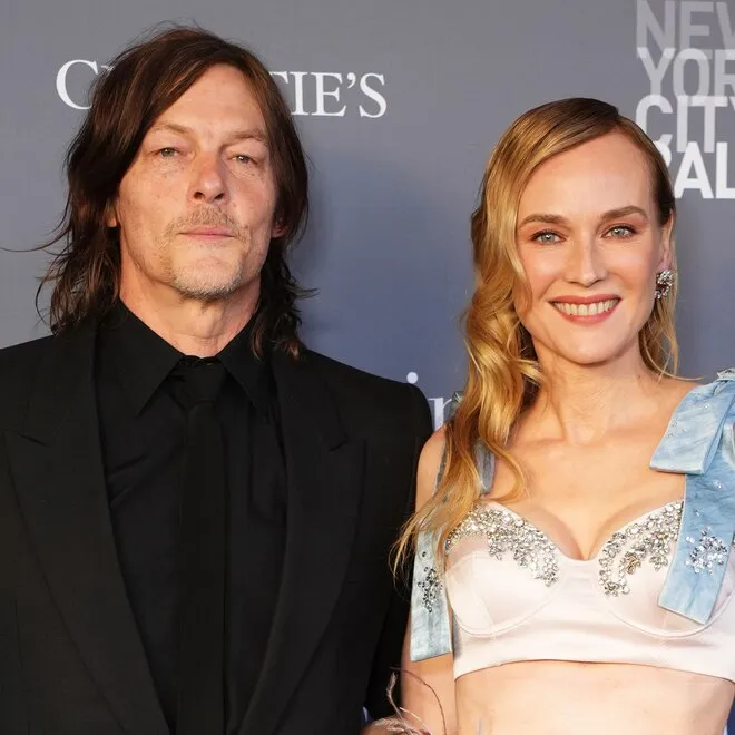 Diane Kruger and Norman Reedus smiling on the red carpet.