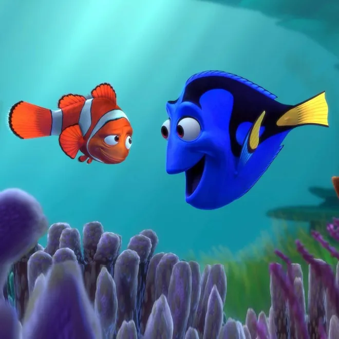 Marlin and Nemo, two clownfish, swimming in the vibrant coral reef.