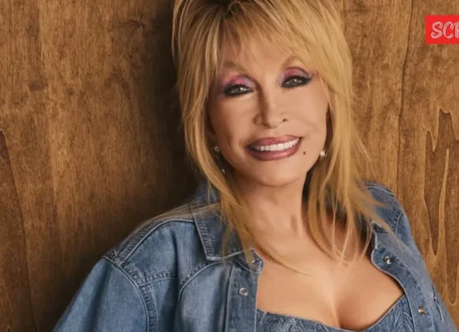 Dolly Parton smiling and wearing a sparkly outfit.