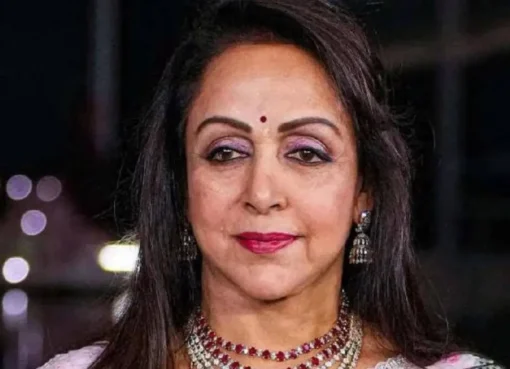 Hema Malini smiling on stage during a performance.