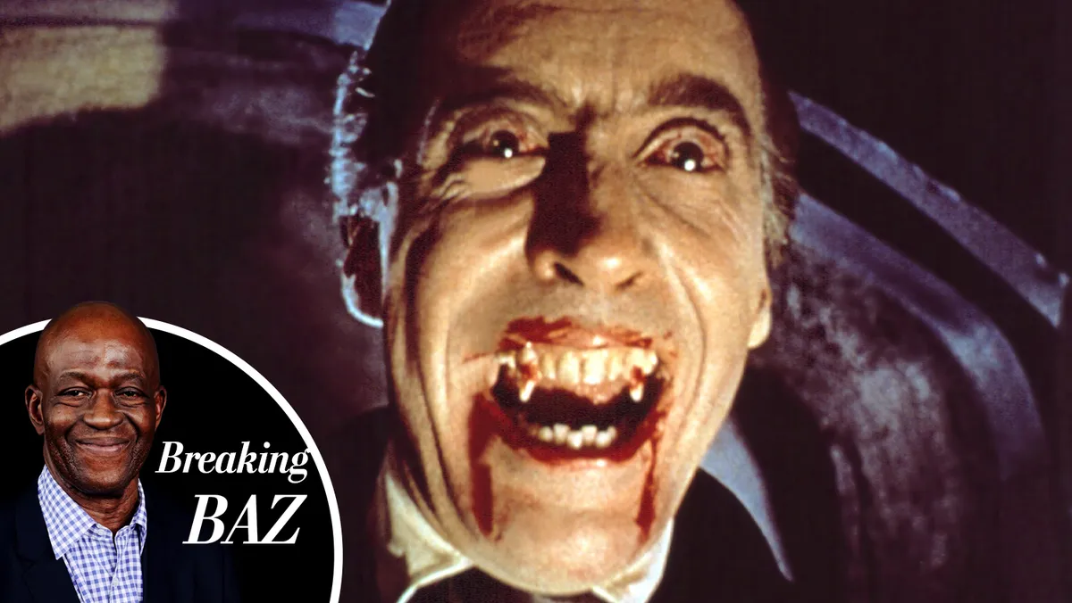 Christopher Lee as Dracula with blood on his fangs, looking menacing.