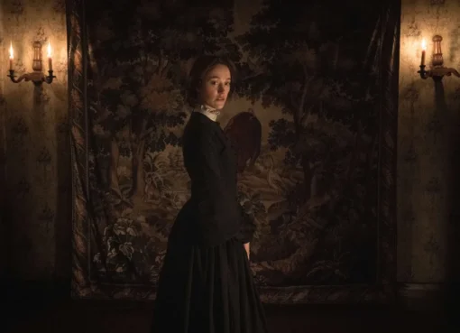 Maika Monroe looking intense and stylish in a Victorian-era dress.