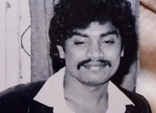A smiling man, known for his comedic acting, looking successful.