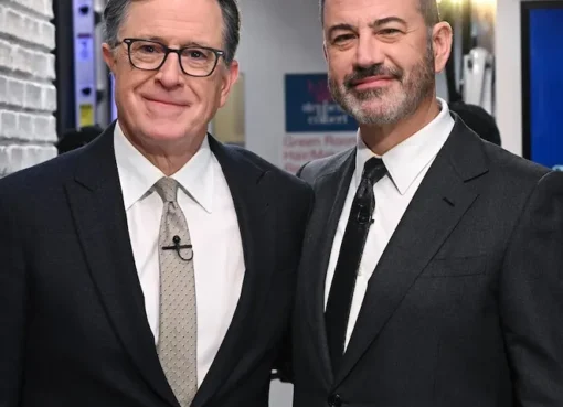 Stephen Colbert smiling on The Late Show set.