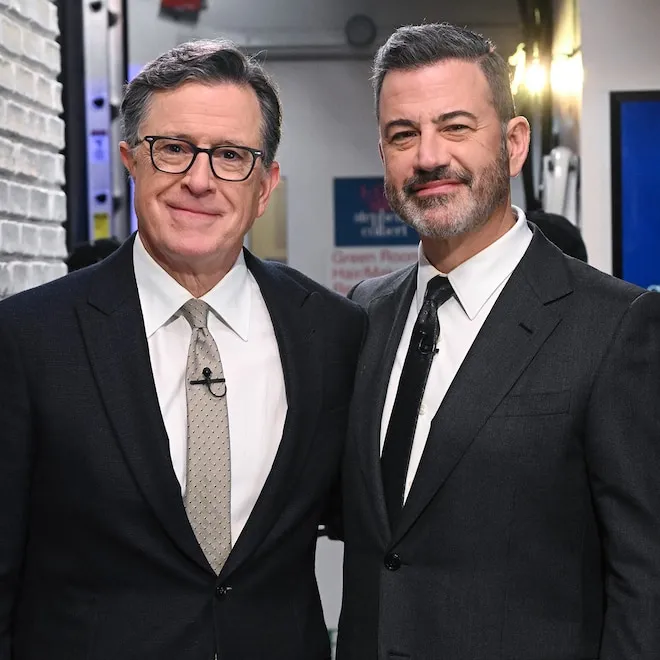 Stephen Colbert smiling on The Late Show set.