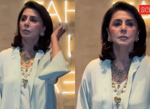 Neetu Kapoor looking surprised at a movie screening with a few photographers.