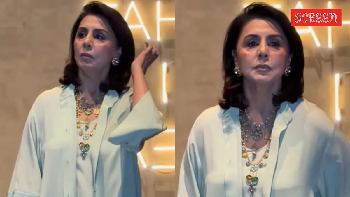 Neetu Kapoor looking surprised at a movie screening with a few photographers.