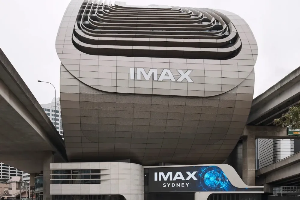 A large IMAX movie theater screen showing a colorful film.