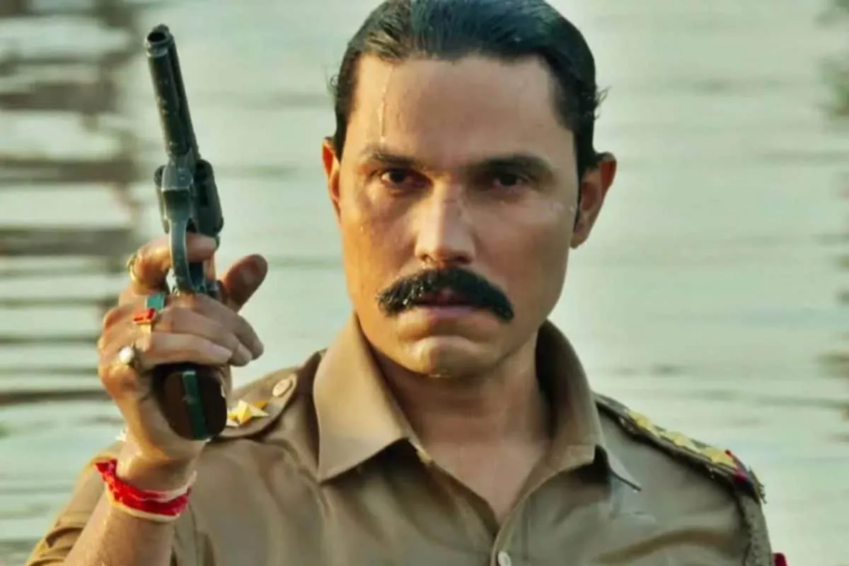 Randeep Hooda in a serious police uniform, looking intensely at the camera.