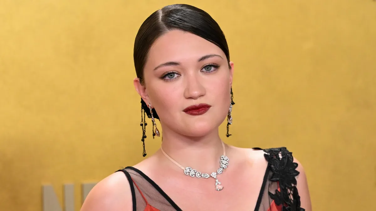 Isa Briones performing on a Broadway stage with bright lights