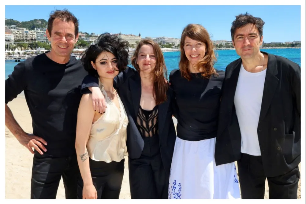 A group of diverse film directors smiling, representing the raw, independent aesthetic of the Dogma 25 movement.