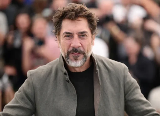 Javier Bardem speaking intently at a press conference in Cannes.