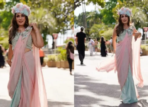 A woman wearing a flowing saree-gown with a Nehru topi.