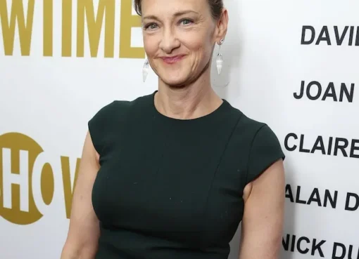 Joan Cusack smiling on a red carpet.