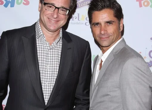 John Stamos and Bob Saget smiling in a photograph.