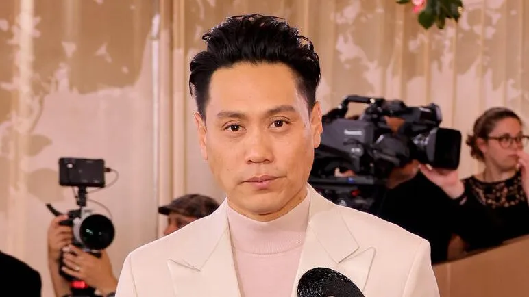 Jon M. Chu smiling at a panel discussion.