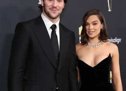 Josh Allen and Hailee Steinfeld smiling together at a public event.