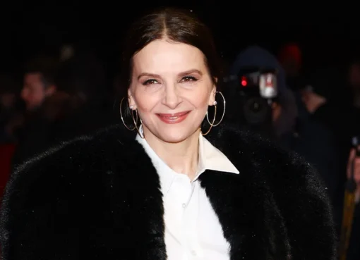 Juliette Binoche looking thoughtful during an interview about her documentary.
