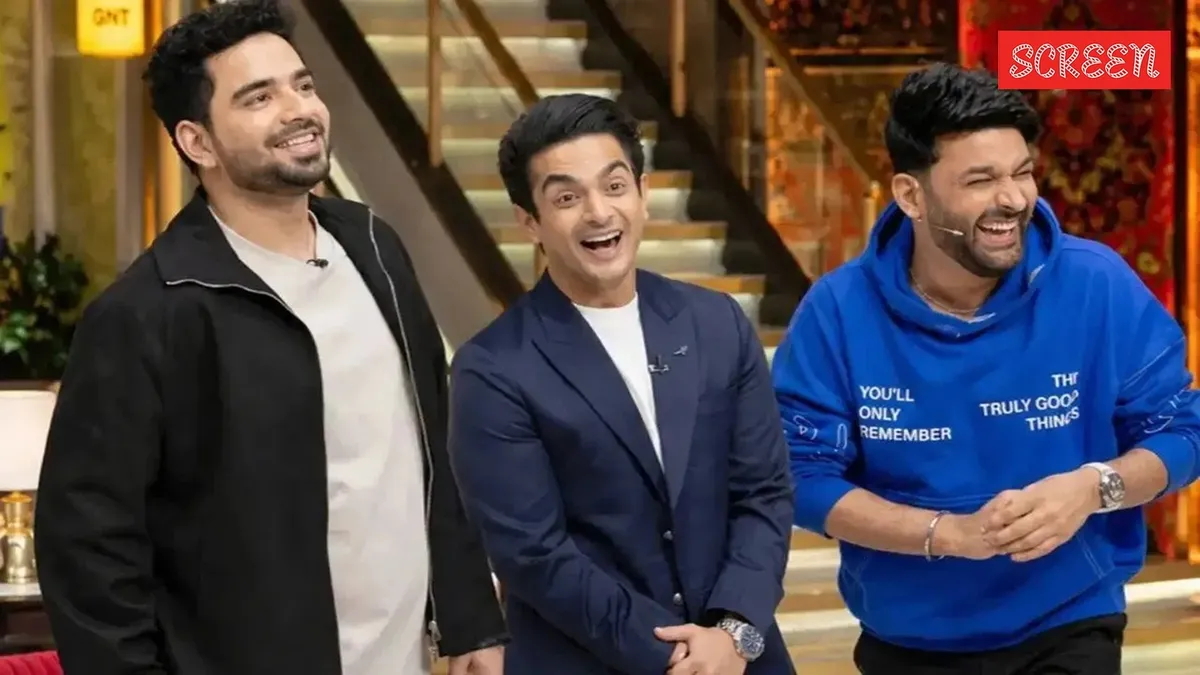 Kapil Sharma and Samay Raina looking serious on a stage with studio lights.