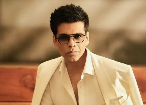 Karan Johar smiling and looking stylish.