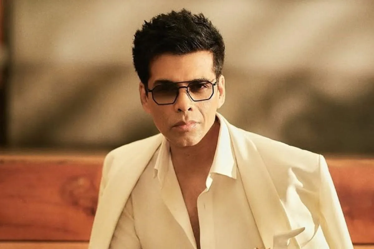 Karan Johar smiling and looking stylish.