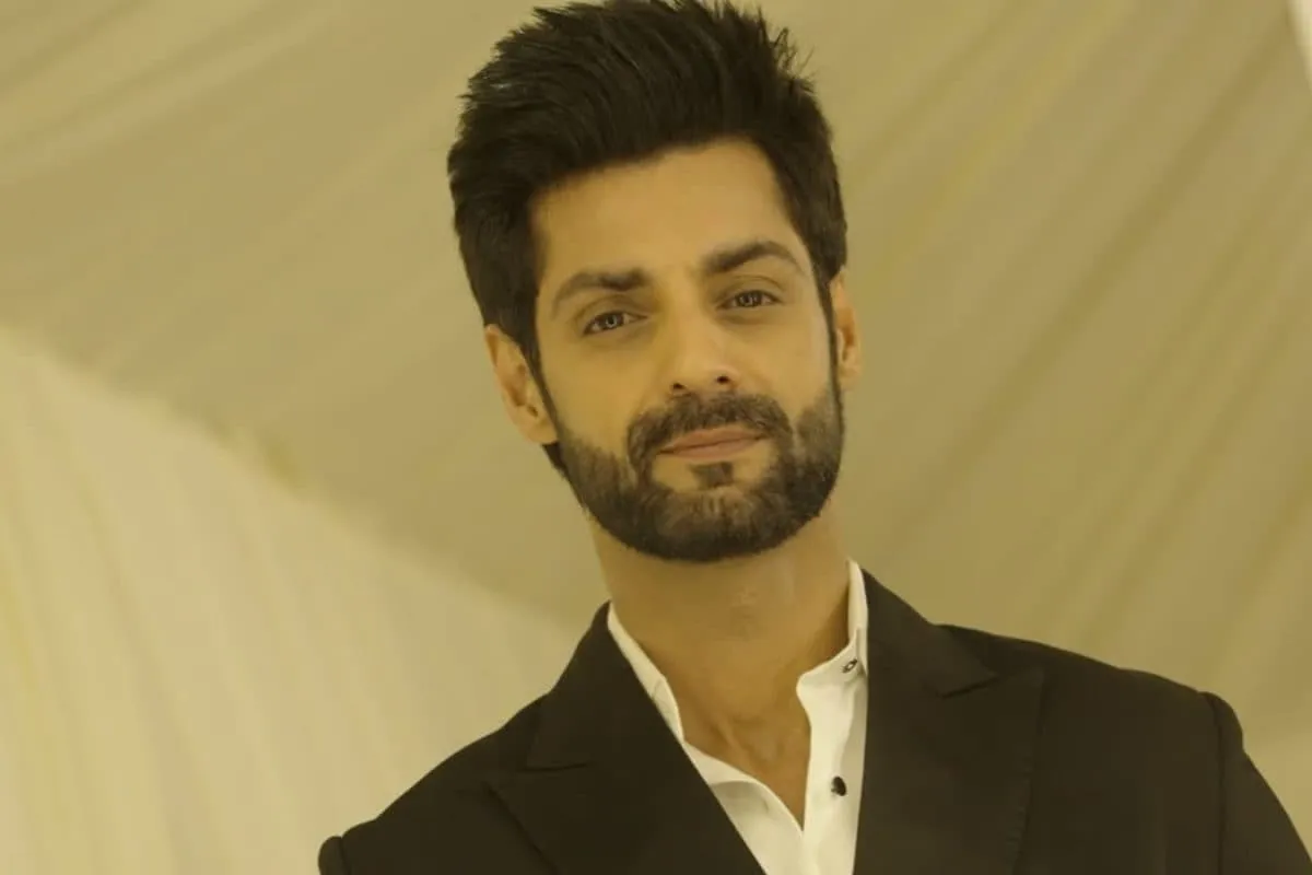 Actor Karan Wahi making a thoughtful expression, perhaps pondering a difficult decision.