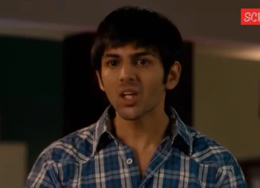 A close-up of actor Kartik Aaryan smiling softly.