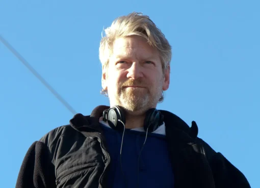 Close-up of Kenneth Branagh smiling and looking thoughtful.