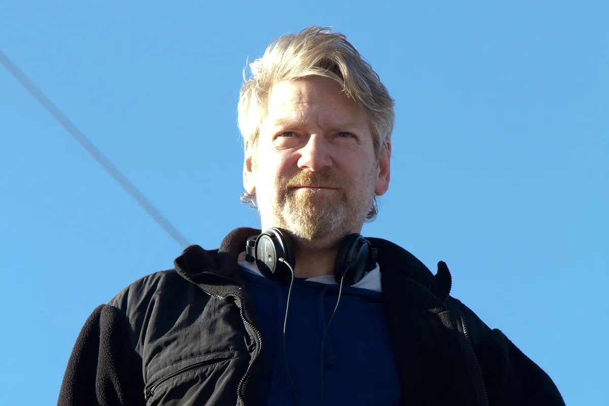 Close-up of Kenneth Branagh smiling and looking thoughtful.