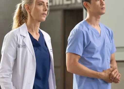 Doctors in scrubs looking concerned in a hospital hallway.