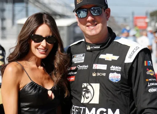 Kyle Busch with his wife Samantha and their two children, smiling.
