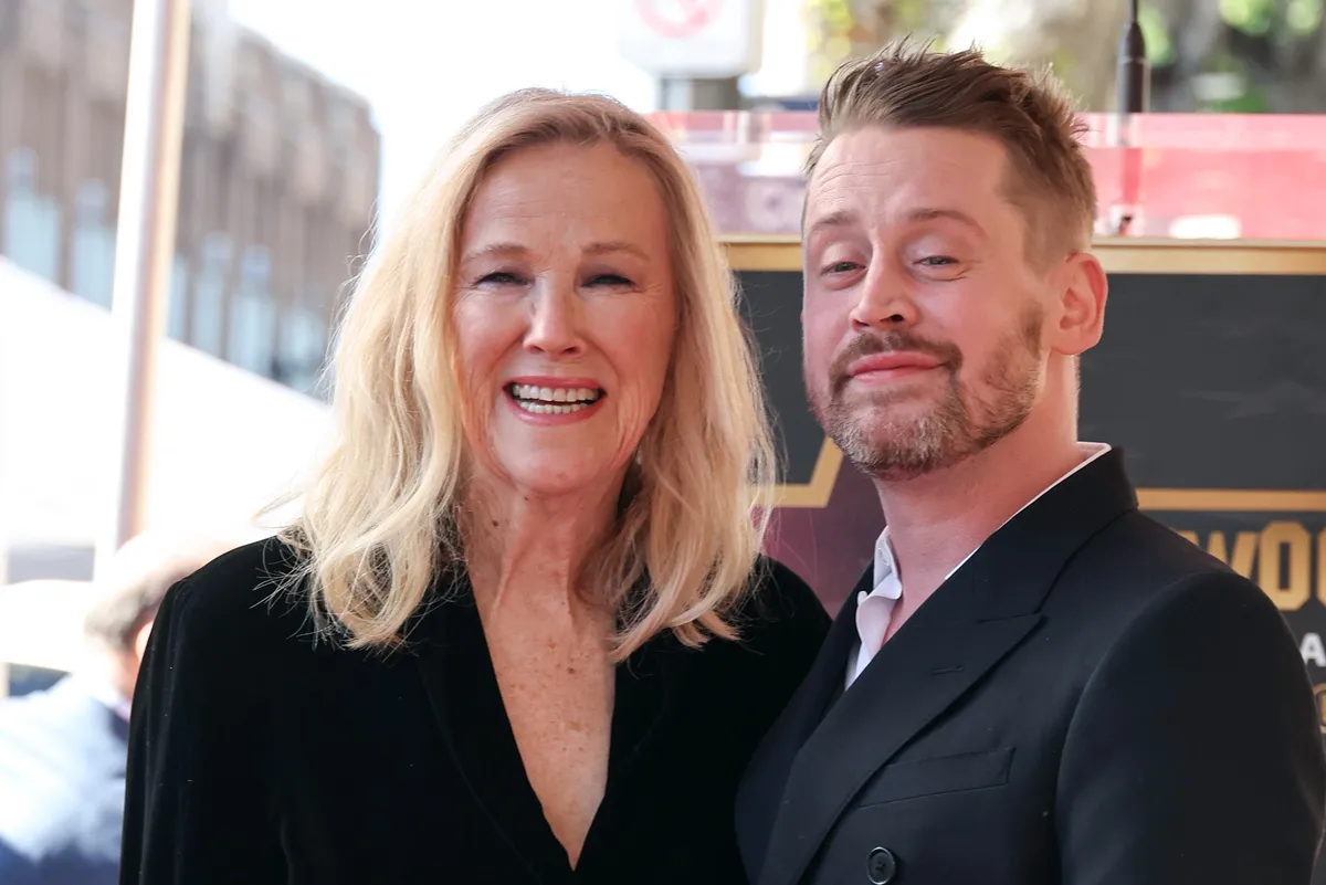 Macaulay Culkin and Catherine O'Hara smiling together in a promotional photo.