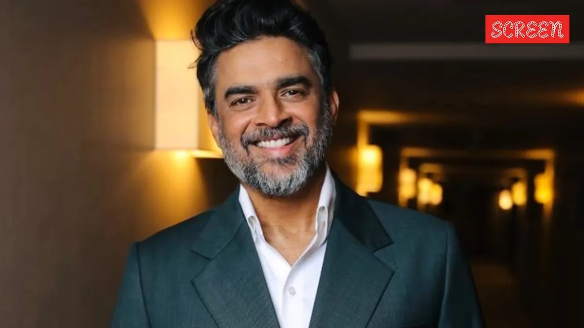 R. Madhavan looking serious, perhaps reacting to a screen displaying a fake advertisement.