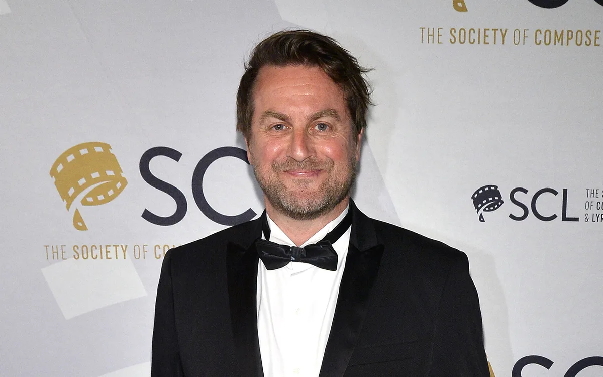 A close-up photo of composer Mark Smythe smiling gently.