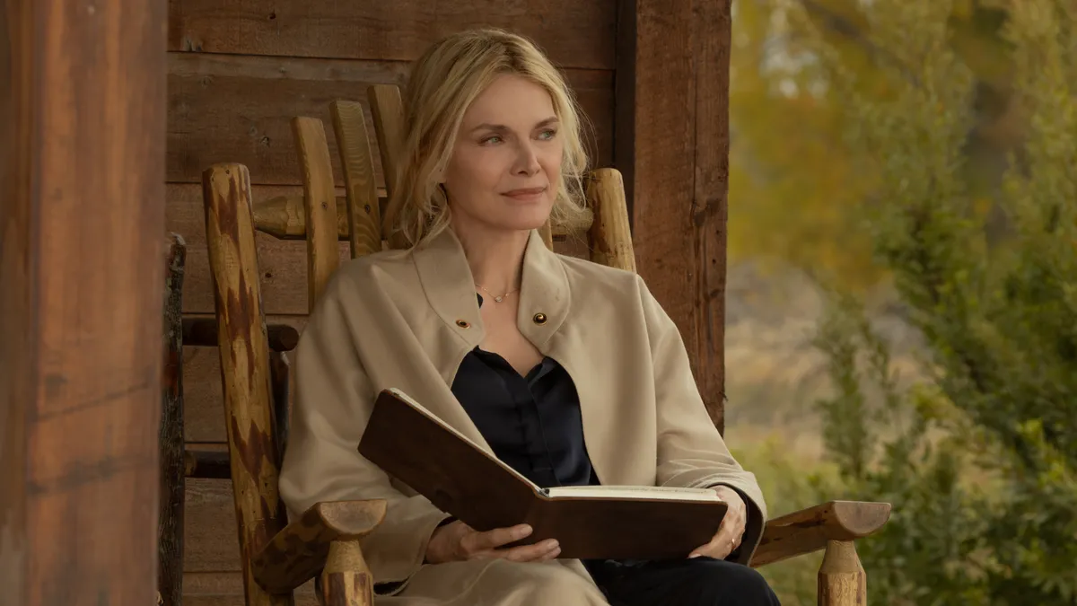 Michelle Pfeiffer looking thoughtful on a TV set
