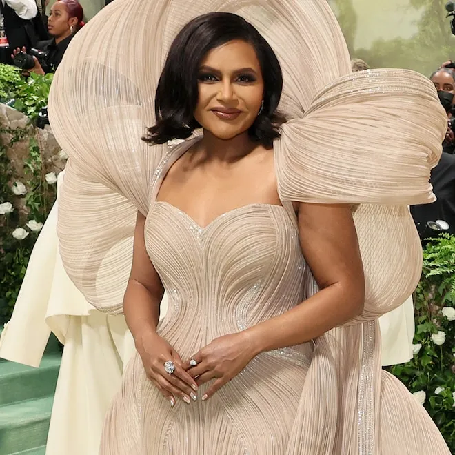 Mindy Kaling smiling warmly and genuinely, looking healthy and happy.