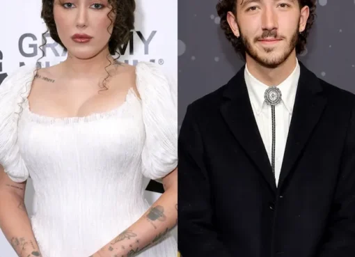 Noah Cyrus and Franklin Jonas smiling and showing off their matching tattoos.