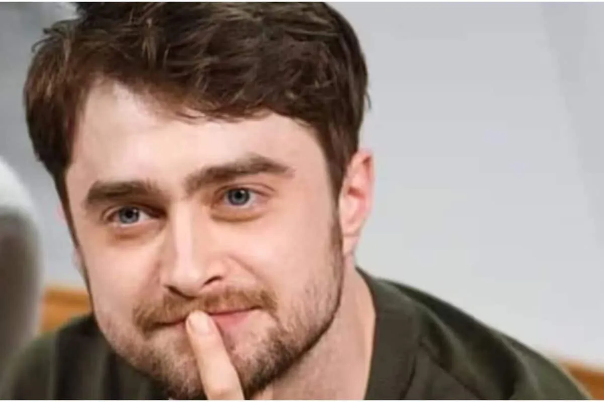 Daniel Radcliffe smiling with his son.