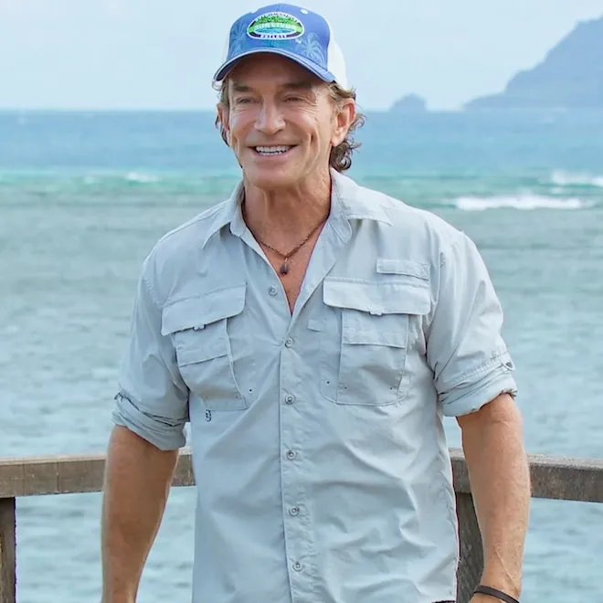 Jeff Probst holding a torch on the Survivor set.
