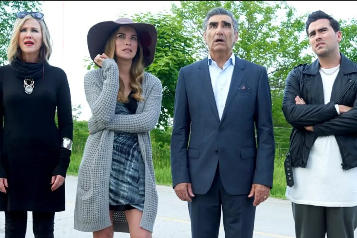 The Rose family posing dramatically in front of their motel.