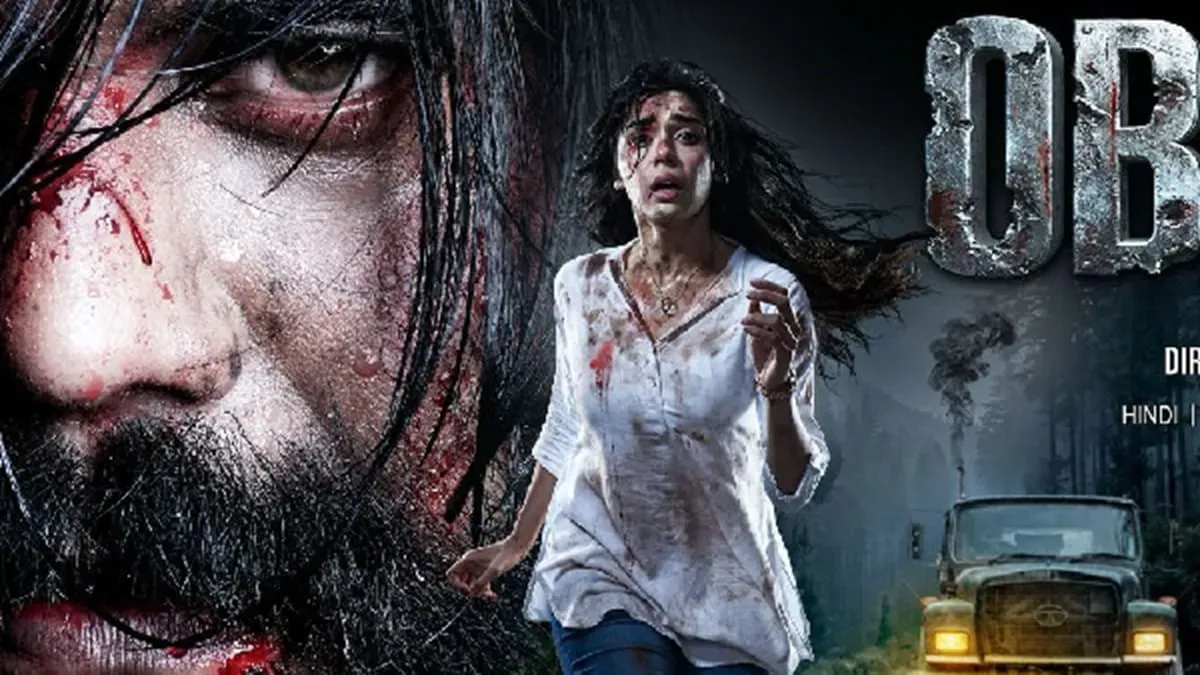 Eisha Singh and Peter Wilson in a still from the 'Obsess' trailer, looking intense and serious.