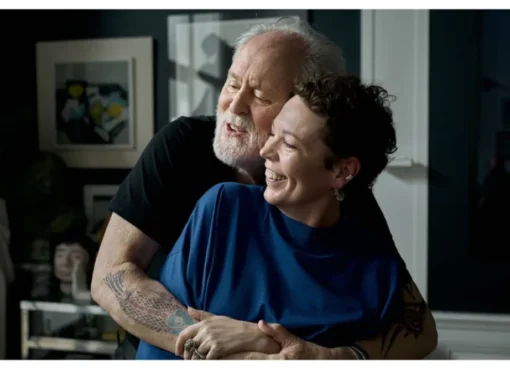 Olivia Colman and John Lithgow smiling together.
