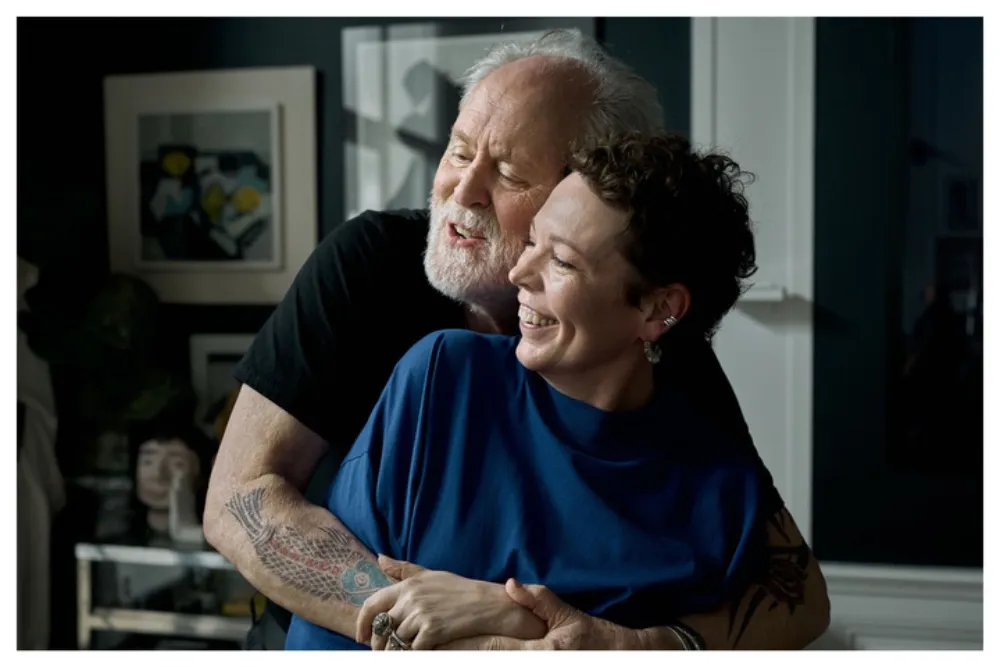Olivia Colman and John Lithgow smiling together.