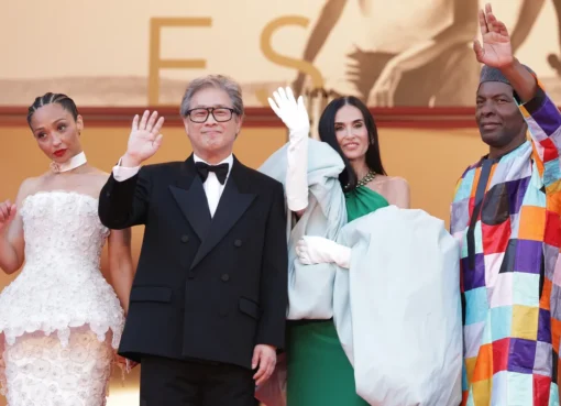 Director Park Chan-wook smiling and laughing at a press conference.