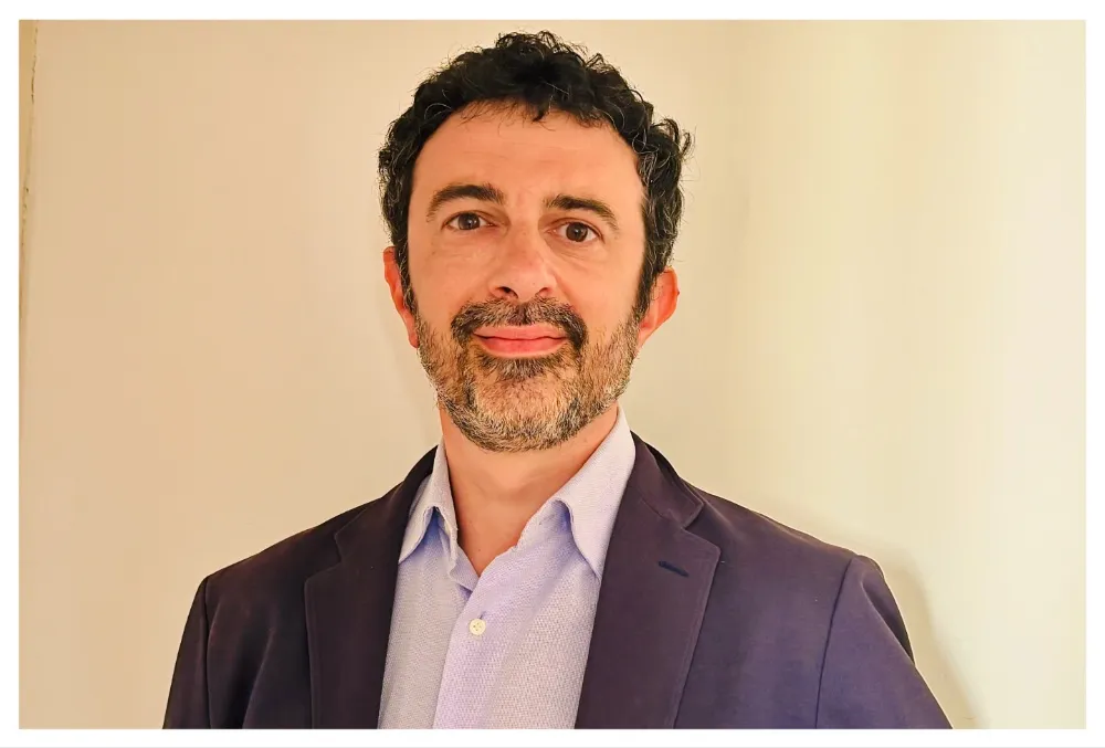 Lorenzo Gangarossa, an Italian film producer, smiling thoughtfully.